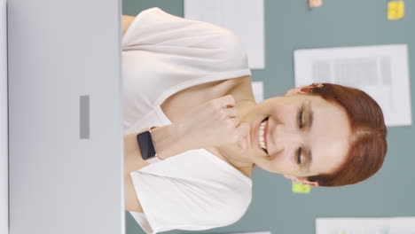 Vertical-video-of-Woman-working-on-laptop-with-happy-expression.